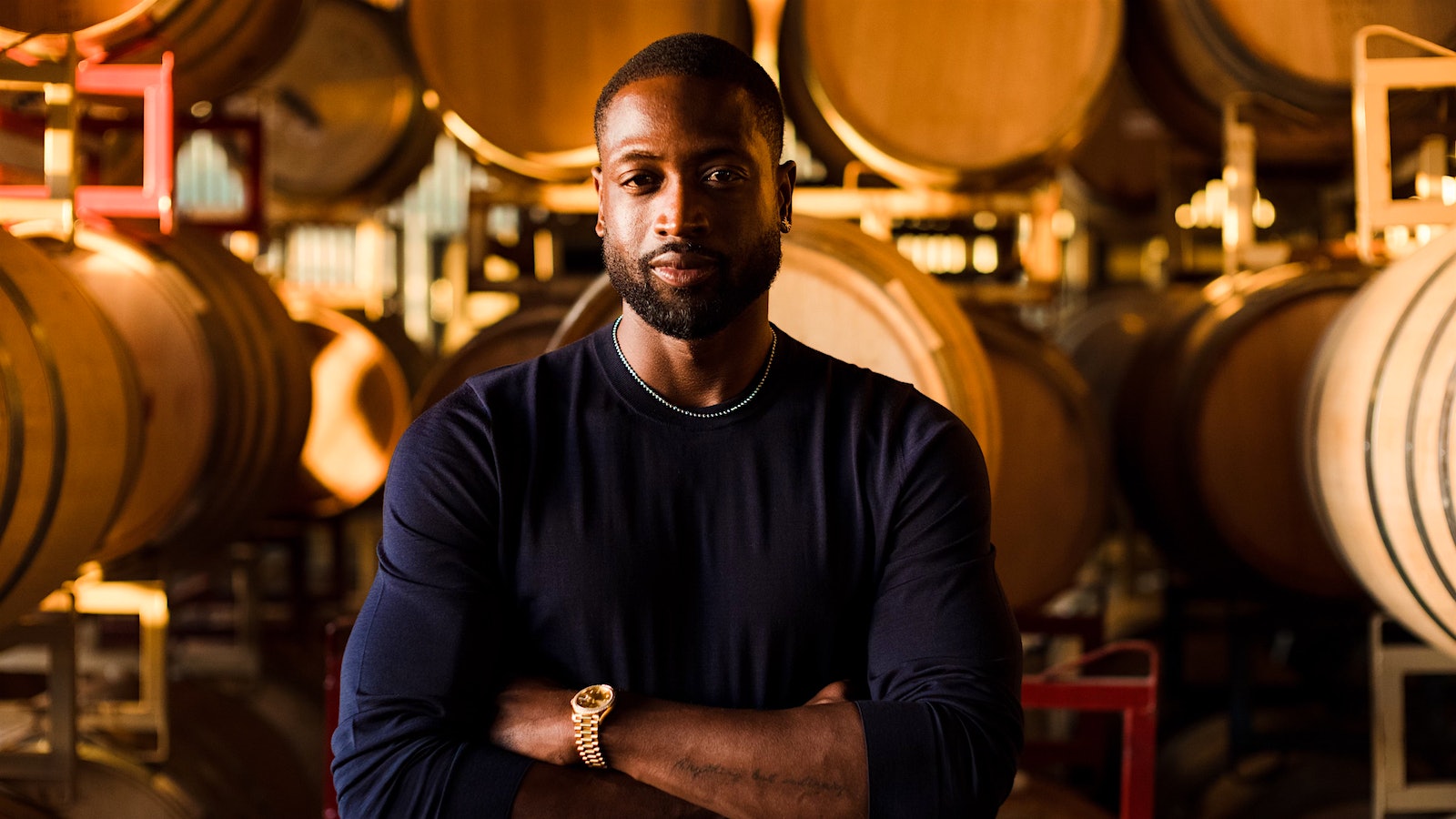 Retired NBA great Dwyane Wade stands in a Napa barrel cellar.